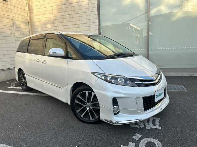 トヨタ エスティマ アエラス プレミアムエディション 埼玉県 2015(平27)年 12.6万km ホワイトパールクリスタルシャイン モデリスタエアロ/純正SD・T-Connect8インチナビ（NSZA-X64T）/　DTV/CD/DVD/BT/SD/SDREC/両側パワースライドドア/バックカメラ/ハーフレザーシート/純正フリップダウンモニター（V11T-R62C）/2列目オットマン/ウォークスルー/クルーズコントロール/TRC（トラクションコントロール）/ビルトインETC/エンジンスタートボタン/スマートキー/純正HIDヘッドライト/フォグランプ/オートライト/純正アルミホイール