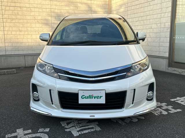 トヨタ エスティマ アエラス プレミアムエディション 埼玉県 2015(平27)年 12.6万km ホワイトパールクリスタルシャイン モデリスタエアロ/純正SD・T-Connect8インチナビ（NSZA-X64T）/　DTV/CD/DVD/BT/SD/SDREC/両側パワースライドドア/バックカメラ/ハーフレザーシート/純正フリップダウンモニター（V11T-R62C）/2列目オットマン/ウォークスルー/クルーズコントロール/TRC（トラクションコントロール）/ビルトインETC/エンジンスタートボタン/スマートキー/純正HIDヘッドライト/フォグランプ/オートライト/純正アルミホイール