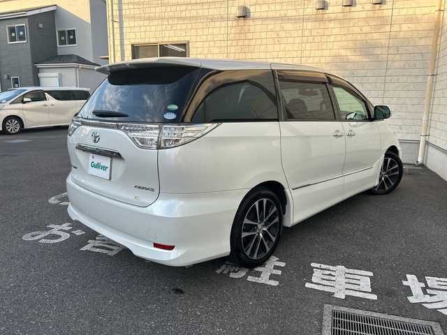 トヨタ エスティマ アエラス プレミアムエディション 埼玉県 2015(平27)年 12.6万km ホワイトパールクリスタルシャイン モデリスタエアロ/純正SD・T-Connect8インチナビ（NSZA-X64T）/　DTV/CD/DVD/BT/SD/SDREC/両側パワースライドドア/バックカメラ/ハーフレザーシート/純正フリップダウンモニター（V11T-R62C）/2列目オットマン/ウォークスルー/クルーズコントロール/TRC（トラクションコントロール）/ビルトインETC/エンジンスタートボタン/スマートキー/純正HIDヘッドライト/フォグランプ/オートライト/純正アルミホイール