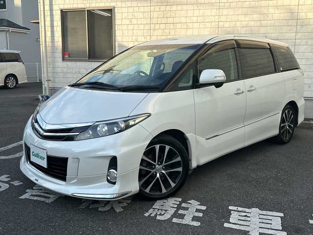 トヨタ エスティマ アエラス プレミアムエディション 埼玉県 2015(平27)年 12.6万km ホワイトパールクリスタルシャイン モデリスタエアロ/純正SD・T-Connect8インチナビ（NSZA-X64T）/　DTV/CD/DVD/BT/SD/SDREC/両側パワースライドドア/バックカメラ/ハーフレザーシート/純正フリップダウンモニター（V11T-R62C）/2列目オットマン/ウォークスルー/クルーズコントロール/TRC（トラクションコントロール）/ビルトインETC/エンジンスタートボタン/スマートキー/純正HIDヘッドライト/フォグランプ/オートライト/純正アルミホイール