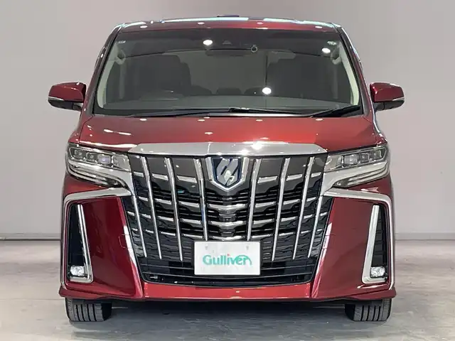 トヨタ アルファードハイブリット SR 宮城県 2019(令1)年 5.1万km ダークレッドマイカメタリック 4WD/ツインムーンルーフ/JBLサウンドシステム/後席モニター/デジタルインナーミラー/トヨタセーフティセンス/・プリクラッシュセーフティ/・レーントレーシングアシスト/・レーダークルーズコントロール/・ロードサインアシスト/・オートマチックハイビーム/純正ナビ/・アラウンドビューモニター/・Bluetooth/CD/・フルセグTV/・USB入力端子/ブラインドスポットモニター/前後コーナーセンサー/リヤクロストラフィックアラート/オートブレーキホールド/電子パーキング/前後ドライブレコーダー/LED2.0/電動リアゲート/革巻きステアリングウッドコンビ/レザーシート/・シートメモリー(運転席)/・シートベンチレーション(運転席・助手席)/・シートヒーター（運転席/助手席）/・オットマン（助手席・2列目）/AC100V充電/LEDヘッドライト/・オートライト/・フォグランプ/純正アルミホイール/純正フロアマット