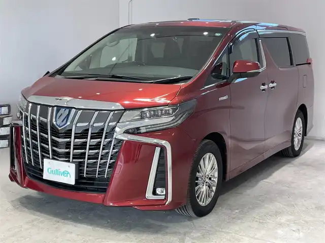 トヨタ アルファードハイブリット SR 宮城県 2019(令1)年 5.1万km ダークレッドマイカメタリック 4WD/ツインムーンルーフ/JBLサウンドシステム/後席モニター/デジタルインナーミラー/トヨタセーフティセンス/・プリクラッシュセーフティ/・レーントレーシングアシスト/・レーダークルーズコントロール/・ロードサインアシスト/・オートマチックハイビーム/純正ナビ/・アラウンドビューモニター/・Bluetooth/CD/・フルセグTV/・USB入力端子/ブラインドスポットモニター/前後コーナーセンサー/リヤクロストラフィックアラート/オートブレーキホールド/電子パーキング/前後ドライブレコーダー/LED2.0/電動リアゲート/革巻きステアリングウッドコンビ/レザーシート/・シートメモリー(運転席)/・シートベンチレーション(運転席・助手席)/・シートヒーター（運転席/助手席）/・オットマン（助手席・2列目）/AC100V充電/LEDヘッドライト/・オートライト/・フォグランプ/純正アルミホイール/純正フロアマット