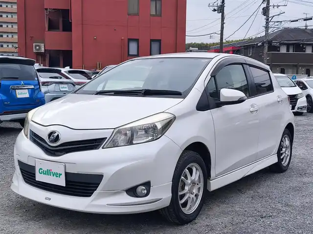 トヨタ ヴィッツ U 熊本県 2012(平24)年 13万km ホワイトパールクリスタルシャイン 4WD/モデリスタエアロ/純正HDDナビ（NHZN-W61G）/【フルセグTV/Bluetooth/CD/DVD】/バックカメラ/ETC/シートヒーター/プッシュスタート/ウインカーミラー/スペアキー/純正フロアマット/社外シートカバー/スペアタイヤ/取扱説明書