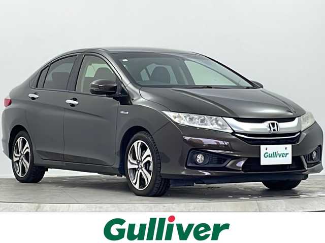 ホンダ グレイス ハイブリッド EX 大阪府 2014(平26)年 8.2万km ゴールドブラウンM 純正ナビ(フルセグTV/FM/AM/CD/DVD/MT/USB)/バックカメラ/前後ドライブレコーダー/ＥＴＣ/横滑り防止装置/盗難防止装置/クルーズコントロール　/パドルシフト/オートライト/ハーフレザー/シートヒーター/純正ＡＷ/純正フロアマット/スマートキー/スペアキー/保証書/記録簿/取扱説明書