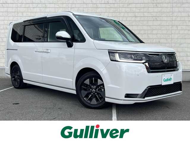 ホンダ ステップワゴン スパーダ 栃木県 2025(令7)年 0.7万km プラチナホワイトパール 禁煙車/ワンオーナー/純正ナビ/Bluetooth/フルセグTV/バックカメラ/後席モニター/ブラインドスポットインフォメーション/全列USBチャージャー/シートヒーター/オットマン/ハーフレザーシート/両側パワースライドドア/電動リアゲート/ETC2.0/パドルシフト/トリプルゾーンコントロール/HONDAセンシング/・コーナーセンサー/・クルーズコントロール/・衝突軽減システム/・アダプティブドライビングビーム/・レーンキープアシスト/・トラフィックジャムアシスト/・オートハイビーム/・カーテンエアバック/・横滑り防止機能