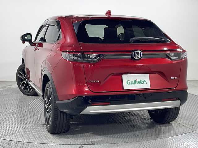 ホンダ ヴェゼル ハイブリッド e:HEV Z 広島県 2021(令3)年 2.7万km プレミアムクリスタルレッドM 9型HondaConnectディスプレイ（ナビ/フルセグTV/AppleCarPlay/AndroidAuto）/パワーテールゲート/シートヒーター/ハーフレザーシート/ステアリングヒーター/ホンダセンシング/・衝突軽減ブレーキ/・レーンキープアシスト/・アダプティブクルーズコントロール/・オートハイビーム/・誤発進抑制機能/・パーキングセンサー/・ブラインドスポットモニター/・後退出庫サポート/ヒルディセントコントロール/減速セレクター/ステアリングスイッチ/電動パーキングブレーキ/オートブレーキホールド/ETC2.0/ワイヤレス充電/USB入力端子/ドライブレコーダー