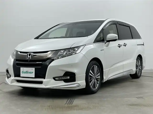ホンダ オデッセイ ハイブリッド アブソルート・EXホンダセンジング 岡山県 2019(平31)年 5.7万km プラチナホワイトパール 無限エアロ(フロント・サイド・リアアンダー)/無限ドアバイザー/純正11.6インチ後席モニター/(VM185EN)/両側電動スライド/純正9インチナビ(VXM-197VFNi)/(Bluetooth/CD/USB/フルセグTV/Carplay/HDMI)/全方位カメラ/100V電源/ハーフレザー/シートヒーター(運転席・助手席)/パワーシート(運転席・助手席)/純正LEDヘッドライト/コーナーセンサー(前後)/純正ドラレコ(前)/ビルトインETC2.0/レーダークルーズコントロール/オートライト/純正フロアマット/純正17インチアルミ