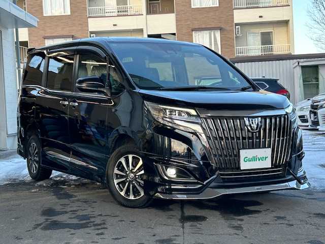 トヨタ エスクァイア Gi プレミアムパッケージ ブラックテーラード 道東・釧路十勝 2019(平31)年 3.2万km ブラック 4WD/寒冷地仕様/ワンオーナー/社外10インチメモリーナビ/　　（DVD/CD/フルセグTV/Bluetooth）/バックカメラ/トヨタセーフティセンス/　　衝突軽減ブレーキ/　　レーンキープアシスト/　　オートマチックハイビーム/クルーズコントロール/社外10.2インチフリップダウンモニター/両側パワースライドドア/フロントワイパーデアイサ―/ハーフレザーシート/前席シートヒーター/アイドリングストップ/ウッドコンビハンドル/ステアリングヒーター/ステアリングリモコン/ビルトインETC/LEDヘッドライト/フォグライト/横滑り防止装置/ウィンカーミラー/電動格納ミラー/運転席シートヒーター/モデリスタフルエアロ/ドライブレコーダー前後/純正ドアバイザー/純正フロアマット/スペアタイヤ/社外レーダー/キーレス一体型純正エンジンスターター/スマートキー/エンジンプッシュスタート/スペアキー/ディーラー記録簿 R4/5/6/取扱説明書/保証書/ナビ取説/純正15インチアルミホイール