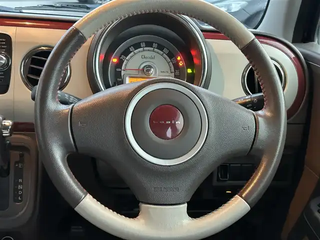 スズキ ラパン ショコラ X 香川県 2014(平26)年 6.9万km カシスピンクパールメタリック 登録時走行距離：68872km/純正ナビゲーション/【地デジ/BT/SD/idod】/衝突被害軽減ブレーキ/バックカメラ/ビルトインETC/アイドリングストップ/HIDヘッドライト/オートライト/横滑り防止装置/誤発進抑制装置/電動格納ミラー/純正フロアマット/ベンチシート/スマートキー/スペアキー