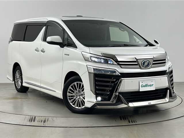 トヨタ ヴェルファイア ハイブリット ZR 埼玉県 2018(平30)年 4.7万km パール 純正10インチナビ/(FM・AM・CD・DVD・SD・BT)/ETC2.0/両側パワースライドドア/レザーシート/オートLEDライト/フルセグテレビ/12型純正フリップダウンモニター/クリアランスソナー/バックカメラ/パワーシート/エアーシート/パワーバックドア/モデリスタエアロ/レーダークルーズコントロール/デジタルミラー/シートポジションメモリー/PCS/車線逸脱警報