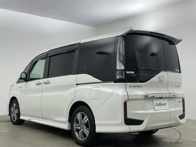 ホンダ ステップワゴン スパーダ ハイブリッド G EX ホンダセンシング 岡山県 2019(平31)年 5.7万km プラチナホワイトパール 純正10インチナビ/（CD/DVD/BT/フルセグTV/HDMI）/フリップダウンモニター/アラウンドビューモニター/両側パワースライドドア/シートヒーター(D/N)/ビルトインETC/レーダークルーズコントロール/LEDヘッドライト/LEDフォグランプ/オートライト/オートブレーキホールド/純正ドライブレコーダー（前）/純正フロアマット/純正ドアバイザー/TVキャンセラー/ISOFIX/リアサーキュレーター/後席サンシェイド/ステアリングスイッチ/チルトステアリング/シートリフター/シートバックテーブル/ウインカーミラー/ドアバイザー/取扱説明書