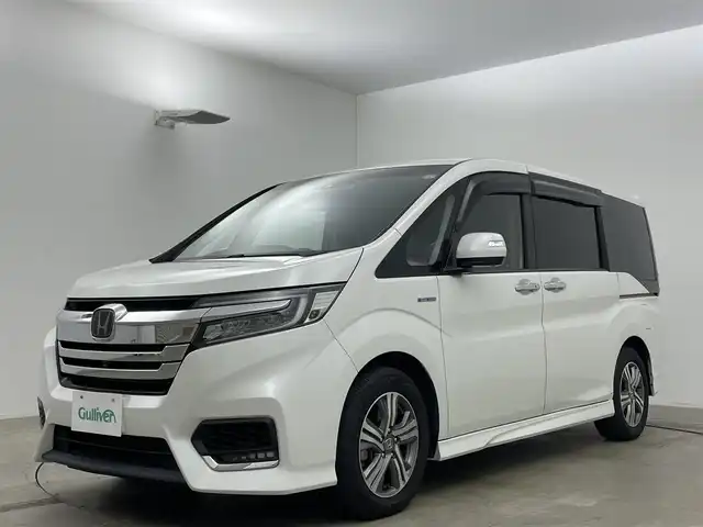 ホンダ ステップワゴン スパーダ ハイブリッド G EX ホンダセンシング 岡山県 2019(平31)年 5.7万km プラチナホワイトパール 純正10インチナビ/（CD/DVD/BT/フルセグTV/HDMI）/フリップダウンモニター/アラウンドビューモニター/両側パワースライドドア/シートヒーター(D/N)/ビルトインETC/レーダークルーズコントロール/LEDヘッドライト/LEDフォグランプ/オートライト/オートブレーキホールド/純正ドライブレコーダー（前）/純正フロアマット/純正ドアバイザー/TVキャンセラー/ISOFIX/リアサーキュレーター/後席サンシェイド/ステアリングスイッチ/チルトステアリング/シートリフター/シートバックテーブル/ウインカーミラー/ドアバイザー/取扱説明書