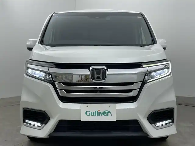 ホンダ ステップワゴン スパーダ ハイブリッド G EX ホンダセンシング 岡山県 2019(平31)年 5.7万km プラチナホワイトパール 純正10インチナビ/（CD/DVD/BT/フルセグTV/HDMI）/フリップダウンモニター/アラウンドビューモニター/両側パワースライドドア/シートヒーター(D/N)/ビルトインETC/レーダークルーズコントロール/LEDヘッドライト/LEDフォグランプ/オートライト/オートブレーキホールド/純正ドライブレコーダー（前）/純正フロアマット/純正ドアバイザー/TVキャンセラー/ISOFIX/リアサーキュレーター/後席サンシェイド/ステアリングスイッチ/チルトステアリング/シートリフター/シートバックテーブル/ウインカーミラー/ドアバイザー/取扱説明書