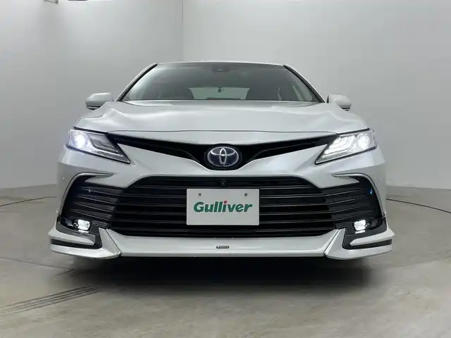 トヨタ カムリ G 岡山県 2023(令5)年 2.6万km プラチナホワイトパールマイカ 純正9インチディスプレイオーディオ(ナビ付)/【AM/FM/CarPlay/BT】/モデリスタエアロ(F/S/R)/パノラミックビューモニター/レーダークルーズコントロール/ビルトインＥＴＣ２．０/衝突軽減ブレーキ /ブラインドスポットモニター/純正アルミ/ドアバイザー/横滑り防止装置/オートLEDヘッドライト/オートハイビーム