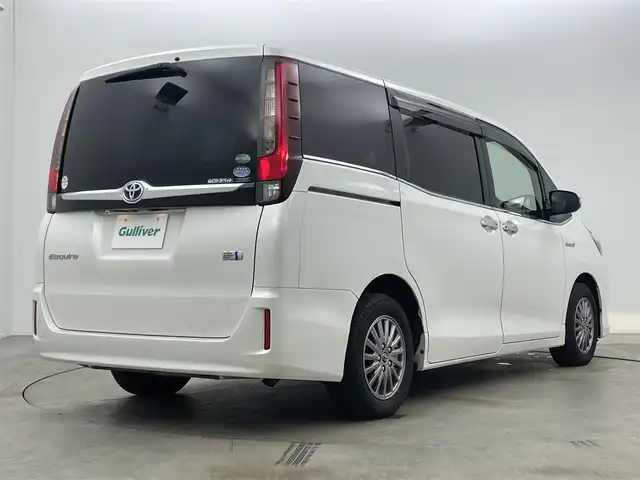 トヨタ エスクァイア ハイブリッド Gi 岡山県 2015(平27)年 7万km ホワイトパールクリスタルシャイン 社外9インチナビ(X900)/(Bluetooth/CD/DVD/フルセグTV)/社外10.1インチ後席モニター(TMX-RM300S)/両側電動スライドドア/合皮シート/シートヒーター(運転席・助手席)/バックカメラ/置くだけ充電/ドアバイザー/クルーズコントロール/純正LEDヘッドライト/オートライト/スマートキー(1本)/純正フロアマット/純正アルミホイール/ビルトインETC/アイドリングストップ