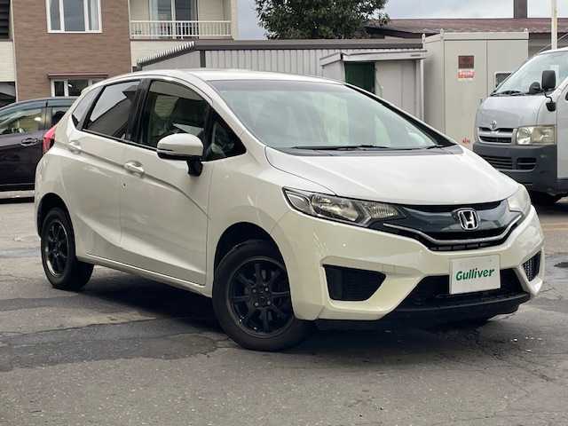 ホンダ フィット 13G Fパッケージ 道東・釧路十勝 2015(平27)年 11.1万km プレミアムホワイトパール 4WD/純正メモリーナビ/  (CD/ラジオ)/アイドリングストップ/ウィンカーミラー/電動格納ミラー/ミラーヒーター/ヘッドライトレベライザー/ETC/純正フロアマット/フロントワイパーデアイサー/スマートキー/エンジンプッシュスタート/スペアキー/社外15インチアルミホイール