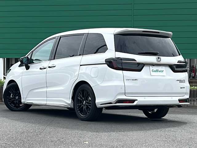 ホンダ オデッセイ ハイブリッド e:HEVアブソルート EXブラックED 茨城県 2023(令5)年 0.4万km プラチナホワイトパール ホンダセンシング/純正11.4インチナビ/ブラインドスポットモニター/衝突軽減システム/レーンキープアシスト/横滑り防止装置/バックカメラ/全周囲カメラ/マルチビューカメラ/両側パワースライドドア/パワーバックドア/レーダークルーズコントロール/LEDオートライト/オートマチックハイビーム/レザーシート/シートヒーター/パワーシート/純正18アルミホイール/SOSボタン/パドルシフト/ワイアレス充電/HDMI/USB入力端子/ETC