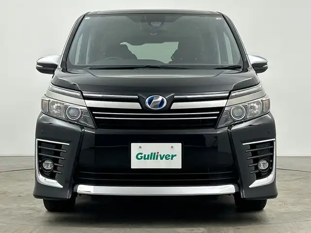 トヨタ ヴォクシー ハイブリッド ZS 煌Ⅱ 三重県 2016(平28)年 2.7万km ブラック /純正9型ナビ（フルセグ/CD/DVD/BT/AM/FM/SD)// バックカメラ //12.8型フリップダウンモニター //両側パワスラ //LEDヘッドライト //前後コーナーセンサー //オートマチックハイビーム //トヨタセーフティーセンス//レーンキープアシスト//TVキャンセラー//スマートキー