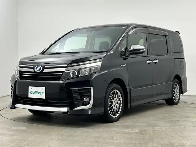 トヨタ ヴォクシー ハイブリッド ZS 煌Ⅱ 三重県 2016(平28)年 2.7万km ブラック /純正9型ナビ（フルセグ/CD/DVD/BT/AM/FM/SD)// バックカメラ //12.8型フリップダウンモニター //両側パワスラ //LEDヘッドライト //前後コーナーセンサー //オートマチックハイビーム //トヨタセーフティーセンス//レーンキープアシスト//TVキャンセラー//スマートキー