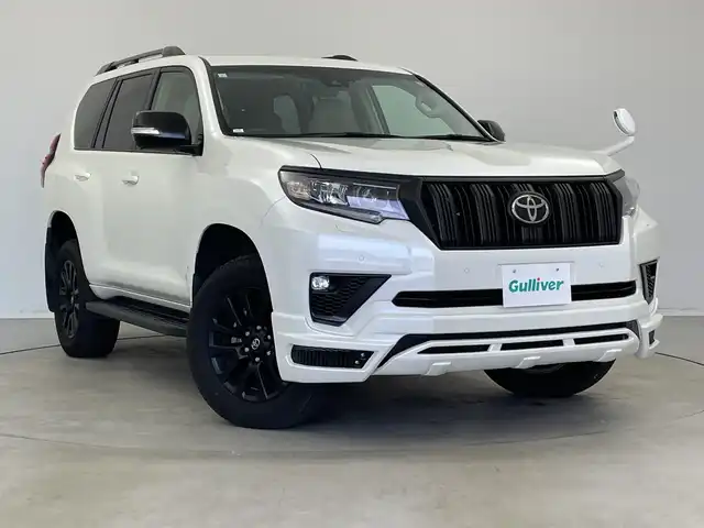トヨタ ランドクルーザー プラド TX Lパッケージ マットブラED 新潟県 2023(令5)年 3.2万km ホワイトパールクリスタルシャイン サンルーフ/7人乗り/ベージュ革シート/プリクラッシュセーフティ/レーダークルーズコントロール/レーンキープアシスト/パーキングサポートブレーキ/ALPINEナビ/　・フルセグTV/　・CD/DVD/SD再生機能/　・Apple car play/　・HDMI/ALPINEフリップダウンモニター/ETC/パワーシート/電動格納サードシート/エアシート/シートヒーター/M’s SPEEDフロントハーフスポイラー/オートライト/オートハイビーム/LEDヘッドライト/プッシュスタート/社外ラバーマット/ステアリングスイッチ/オートドアミラー