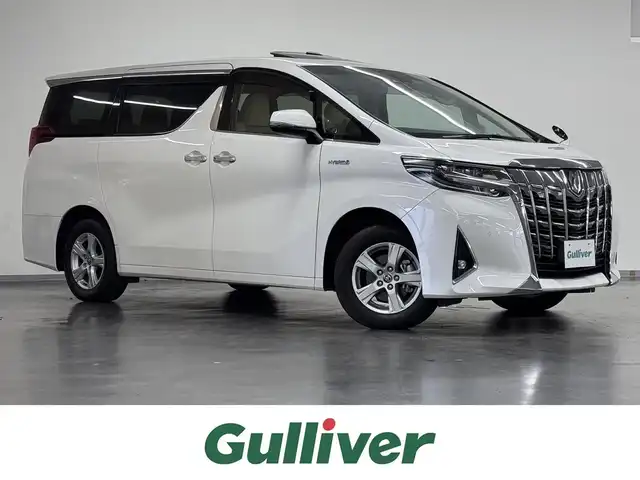 トヨタ アルファードハイブリット X 三重県 2020(令2)年 3.8万km ホワイトパールクリスタルシャイン ハイブリッド/E-Four（4WD）/MTモード付インパネCVT/純正 9インチナビ/（AM/FM/CD/DVD/TV/USB/iPod/Bluetooth/CarPlay/AndroidAuto）/純正 12.1インチ後席モニター V12T-R68C/バックカメラ/両側パワースライドドア/ドライブレコーダー 前後/ビルトイン ETC2.0/Toyota Safety Sense/●プリクラッシュセーフティ/●レーントレーシングアシスト/●オートハイビーム/●レーダークルコン/●ロードサインアシスト/・インテリジェントクリアランスソナー［パーキングサポートブレーキ（静止物）］/装備/・【OP】ツインムーンルーフ/・オットマンシート/・左右＆後席独立オートエアコン/・オートライト/・LED ヘッドランプ＆フロントフォグランプ/・ステアリングスイッチ/・純正16inAW/・電子パーキングブレーキ＆ブレーキホールド/・プッシュスタート/・スマートキーx2、純正リモコンスターターx1/など