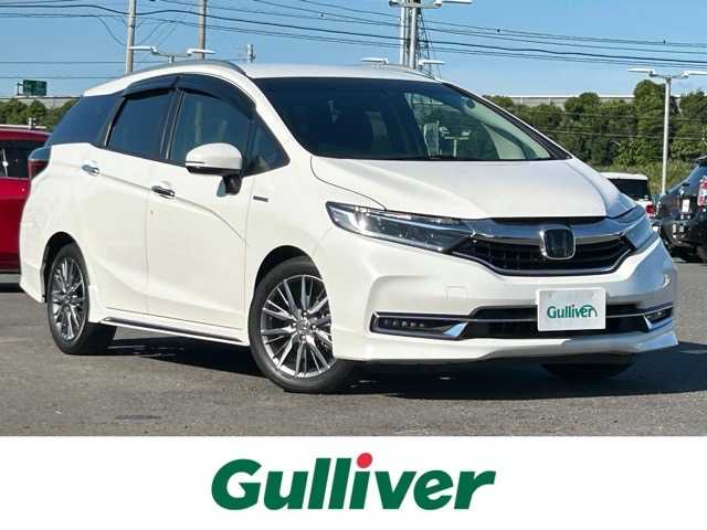 ホンダ シャトル ハイブリッド Z ホンダセンシング 茨城県 2022(令4)年 2.1万km プラチナホワイトパール ワンオーナー/社外8インチナビ/フルセグTV/CD/DVD/Bluetooth/ETC/バックカメラ/衝突軽減ブレーキ/誤発進抑制機能/近距離衝突軽減ブレーキ/歩行者事故低減ステアリング/路外逸脱抑制機能/アダプティブクルーズコントロール/レーンキープアシスト/先行車発進お知らせ機能/標識認識機能/オートハイビーム/ハーフレザーシート/前席シートヒーター/スマートキー/スペアキー×１/ステアリングスイッチ/パドルシフト/純正16インチアルミホイール/保証書・取扱説明書