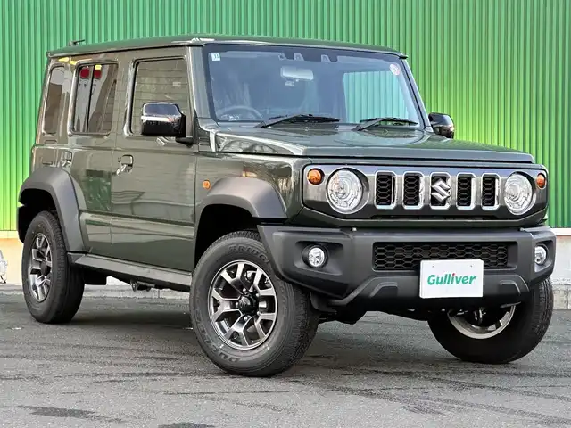 スズキ ジムニー ノマド FC 東京都 2025(令7)年 0.1千km ジャングルグリーン ワンオーナー/パートタイム4WD/衝突被害軽減ブレーキ/純正LEDオートライト/純正フォグ/純正セキュリティアラーム/アダプティブクルーズコントロール/レーンディパーチャーアラート/クリアランスソナー/ダウンヒルアシストコントロール/ウインカードアミラー/本革巻ハンドル/前席シートヒーター/オートエアコン/スマートキー/プッシュエンジンスタート/スペアキー/新車時保証書/取扱い説明書