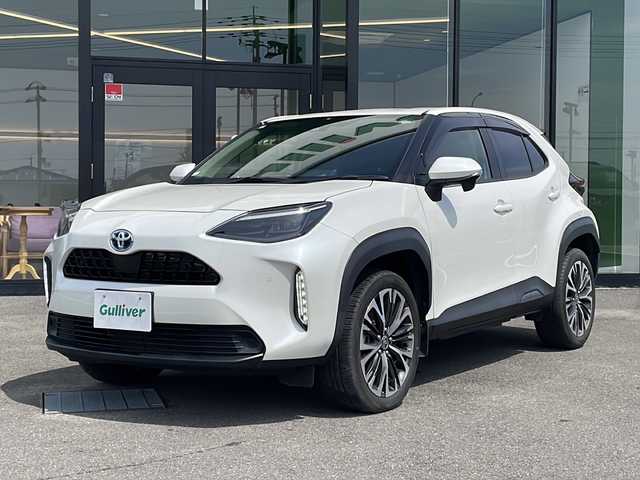 トヨタ ヤリスクロス ハイブリッド Z 愛媛県 2021(令3)年 2.8万km ホワイトパールクリスタルシャイン 純正ナビ/　(CD/DVD/USB/Bluetooth)/バックカメラ/ETC2.0/ステアリングスイッチ/レーダークルーズコントロール/プリクラッシュセーフティ/レーントレーシングアシスト/パーキングサポートブレーキ/ロードサインアシスト/前後コーナーセンサー/プッシュエンジンスタート/ハーフレザー調シート/前席シートヒーター/運転席パワーシート/純正フロアマット/ヘッドライトレベライザー/オートライト/オートハイビーム/LEDヘッドライト/ウィンカー付き電動格納ミラー/ドアバイザー