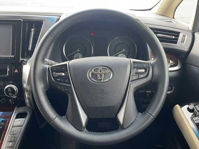 トヨタ ヴェルファイア X 岩手県 2015(平27)年 5.2万km ホワイトパールクリスタルシャイン 純正9インチナビ/CD/DVD/Bluetooth/フルセグTV/純正フリップダウンモニター/バックカメラ/ビルトインETC/両側パワースライドドア/コーナーセンサー/革調シートカバー/アイドリングストップ/オートライト/LEDヘッドライト/スマートキー/プッシュスタート/電動格納ミラー/純正16インチAW/フロアマット/ドアバイザー