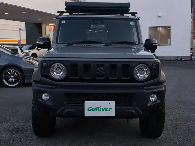 スズキ ジムニー シエラ JC 熊本県 2021(令3)年 1.5万km ミディアムグレー ワンオーナー/1インチリフトアップ車/ルーフキャリア/サイドステップバー/リアラダー/サイドラック（ロトパックス）/社外8インチナビ（CN-RZ865）/【フルセグTV/Bluetooth再生/CD/DVD】/車線逸脱警報システム/デュアルセンサーブレーキサポート/シートヒーター/LEDオートライト/フォグライト/ビルトインETC/純正15インチAW/純正フロアマット/ドアバイザー/保証書/取扱説明書