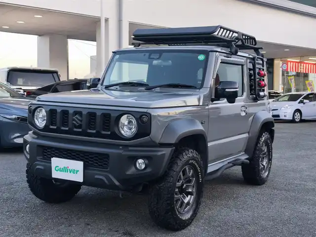 スズキ ジムニー シエラ JC 熊本県 2021(令3)年 1.5万km ミディアムグレー ワンオーナー/1インチリフトアップ車/ルーフキャリア/サイドステップバー/リアラダー/サイドラック（ロトパックス）/社外8インチナビ（CN-RZ865）/【フルセグTV/Bluetooth再生/CD/DVD】/車線逸脱警報システム/デュアルセンサーブレーキサポート/シートヒーター/LEDオートライト/フォグライト/ビルトインETC/純正15インチAW/純正フロアマット/ドアバイザー/保証書/取扱説明書
