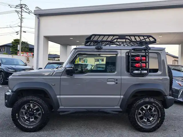 スズキ ジムニー シエラ JC 熊本県 2021(令3)年 1.5万km ミディアムグレー ワンオーナー/1インチリフトアップ車/ルーフキャリア/サイドステップバー/リアラダー/サイドラック（ロトパックス）/社外8インチナビ（CN-RZ865）/【フルセグTV/Bluetooth再生/CD/DVD】/車線逸脱警報システム/デュアルセンサーブレーキサポート/シートヒーター/LEDオートライト/フォグライト/ビルトインETC/純正15インチAW/純正フロアマット/ドアバイザー/保証書/取扱説明書