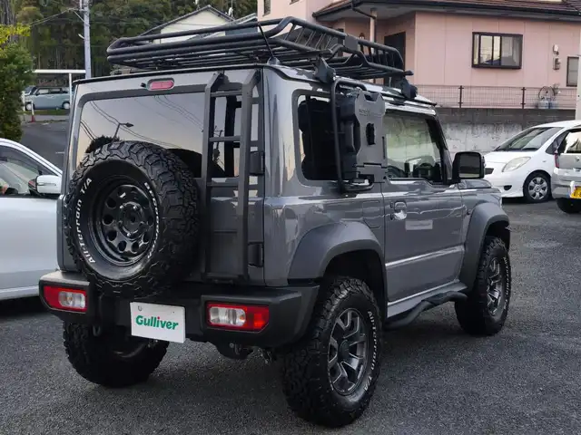 スズキ ジムニー シエラ JC 熊本県 2021(令3)年 1.5万km ミディアムグレー ワンオーナー/1インチリフトアップ車/ルーフキャリア/サイドステップバー/リアラダー/サイドラック（ロトパックス）/社外8インチナビ（CN-RZ865）/【フルセグTV/Bluetooth再生/CD/DVD】/車線逸脱警報システム/デュアルセンサーブレーキサポート/シートヒーター/LEDオートライト/フォグライト/ビルトインETC/純正15インチAW/純正フロアマット/ドアバイザー/保証書/取扱説明書