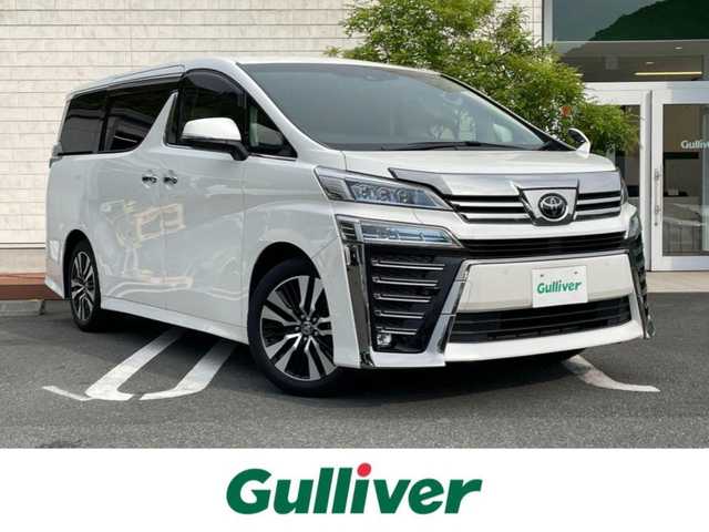 トヨタ ヴェルファイア Z Gエディション 愛媛県 2020(令2)年 1.4万km ホワイトパールクリスタルシャイン ワンオーナー/純正ディスプレイオーディオナビ/12.1インチ純正フリップダウンモニター/・Bluetooth/・CD/DVD/・USB入力端子/フルセグTV（走行時視聴可能）/バックカメラ/ビルドインETC/ドライブレコーダー/両側パワースライドドア/パワーバックドア/レザーシート/パワーシート/快適温熱シート/ステアリングヒーター/プリクラッシュセーフティシステム（ＰＣＳ）/レーントレーシングアシスト（ＬＴＡ）/レーダークルーズコントロール/オートマチックハイビーム（ＡＨＢ）/コーナーセンサー/純正フロアマット/純正18インチAW/LEDヘッドライト/カーテンエアバッグ/スペアキー/スマートキー/取扱説明書