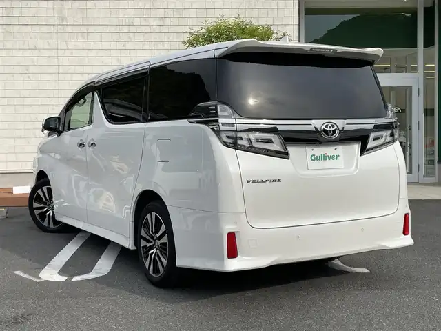 トヨタ ヴェルファイア Z Gエディション 愛媛県 2020(令2)年 1.4万km ホワイトパールクリスタルシャイン ワンオーナー/純正ディスプレイオーディオナビ/12.1インチ純正フリップダウンモニター/・Bluetooth/・CD/DVD/・USB入力端子/フルセグTV（走行時視聴可能）/バックカメラ/ビルドインETC/ドライブレコーダー/両側パワースライドドア/パワーバックドア/レザーシート/パワーシート/快適温熱シート/ステアリングヒーター/プリクラッシュセーフティシステム（ＰＣＳ）/レーントレーシングアシスト（ＬＴＡ）/レーダークルーズコントロール/オートマチックハイビーム（ＡＨＢ）/コーナーセンサー/純正フロアマット/純正18インチAW/LEDヘッドライト/カーテンエアバッグ/スペアキー/スマートキー/取扱説明書