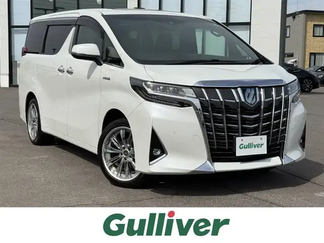 トヨタ アルファードハイブリット エグゼクティブ ラウンジ 道南・函館 2018(平30)年 8.7万km ホワイトパールクリスタルシャイン ・スマートキー＆プッシュスタート/・スペアキー/・スマートキー一体型エンジンスターター/・夏タイヤ積込み/・ワンオーナー/・寒冷地仕様/・ツインムーンルーフ/・JBLプレミアムサウンド/・レーダークルーズコントロール/・ビルトインＥＴＣ/・純正フロアマット/・ナビ(Bluetooth/SD/USB/CD/HDMI/TV)/・フリップダウンモニター/・バックカメラ/・全方位カメラ/・全席シートヒーター/・全席エアシート/・全席パワーシート/・デジタルインナーミラー/・電動リアゲート/・社外19インチAW