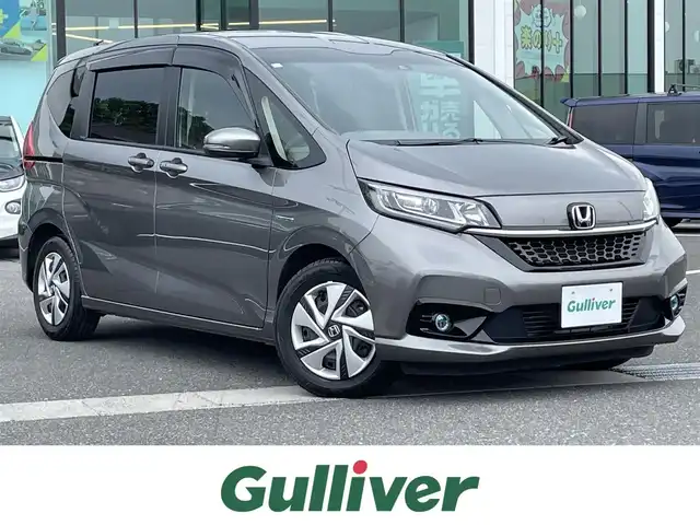 ホンダ フリード ハイブリット G ホンダセンシング 島根県 2020(令2)年 3.1万km スーパープラチナグレーメタリック ワンオーナー /純正9インチナビ/CD/DVD/DTV/Bluetooth/USB/バックカメラ/レーダークルーズコントロール/両側パワースライドドア /シートヒーター /LEDオートライト/ステアリングスイッチ/純正ホイール付きスタッドレス積込/ビルトインETC/前後ドライブレコーダー/スマートキー/スペアキー /プッシュスタート /純正フロアマット/ドアバイザー/電動格納ミラー/フロントワイパーデアイサー
