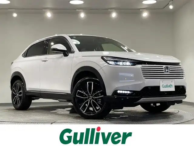 ホンダ ヴェゼル ハイブリッド e:HEV Z 愛知県 2025(令7)年 0.1千km プラチナホワイトパール 登録済未使用車/純正９インチホンダコネクトディスプレイナビ　/(Bluetooth/フルセグTV/USB/スマートフォン連携/FM/AM)/ホンダセンシング　/　　-衝突軽減ブレーキ（CMBS)/　　-誤発進抑制機能/　　-路線逸脱抑制機能/　　-アダプティブクルーズコントロール/　　-車線維持支援システム/　　-オートハイビーム/　　-先行車発進お知らせ/　　-標識認識機能/ビルトインＥＴＣ２．０　/ＬＥＤヘッドライト/LEDフォグランプ　/バックカメラ　/ワイヤレス充電　/シートヒーター/ステアリングヒーター　/電動バックドア　/ブラインドスポットモニター（ＢＳＭ）/コーナーセンサー/パドルシフト/プッシュスタート/　　-スマートキー