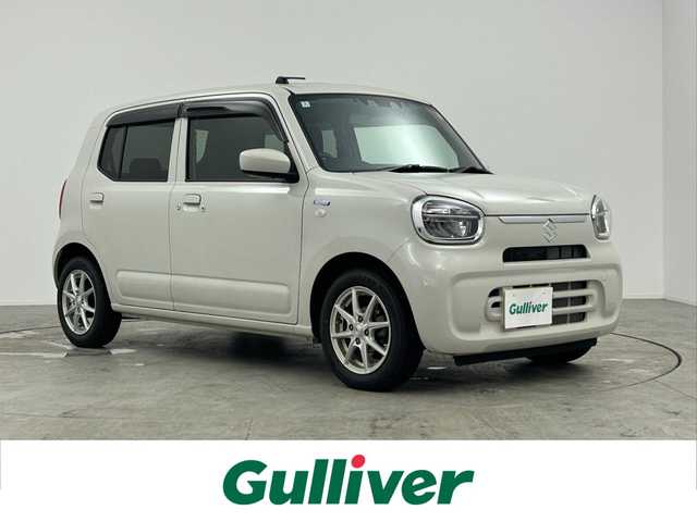 スズキ アルト ハイブリッドX 愛知県 2024(令6)年 1.1万km ソフトベージュメタリック 純正7型メモリナビ　/(フルセグＴＶ/CD/DVD/BT/SD)/前席シートヒーター　/前後ドラレコ　/ＥＴＣ　/衝突軽減システム　/レーンアシスト　/アイドリングストップ　/純正ＬＥＤヘッドライト　/純正フロアマット　/純正１４インチＡＷ　/ドアバイザー