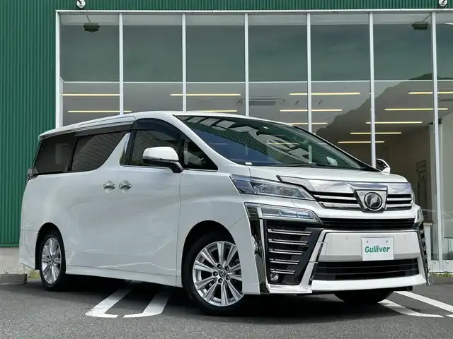 トヨタ ヴェルファイア Z 愛媛県 2019(令1)年 2.3万km ホワイトパールクリスタルシャイン 純正10.5インチメモリナビ【NSZN-Z68T】/純正12.1インチフリップダウンモニター/・CD/DVD /・Bluetooth /フルセグTV/バックカメラ/両側パワースライドドア/ビルトインETC/トヨタセーフティセンス/プリクラッシュセーフティ/レーンキープアシスト/コーナーセンサー/レーダークルーズコントロール/オットマン/純正LEDヘッドライト/フォグランプ/純正フロアマット/純正18インチAW/オートハイビーム/プッシュスタート/スマートキー/スペアキー/保証書/取扱説明書