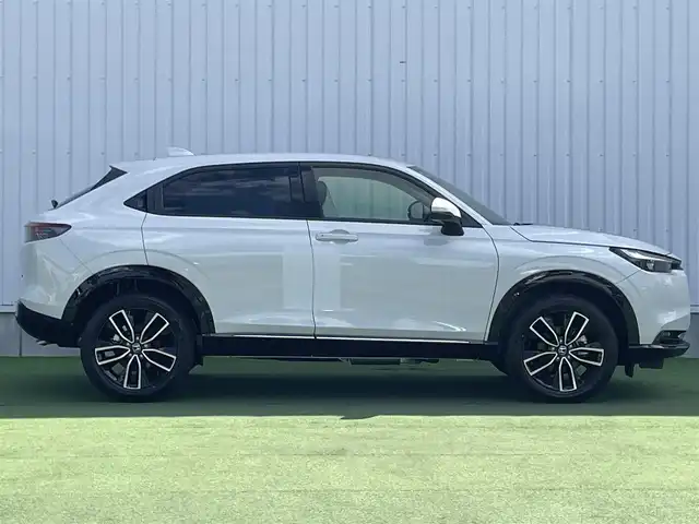 ホンダ ヴェゼル ハイブリッド e:HEV Z 香川県 2025(令7)年 0.1千km プラチナホワイトパール 登録時走行距離：3km/ホンダセンシング/純正9インチナビ/ホンダコネクトディスプレイ/ワイヤレス充電/バックカメラ/レーダークルーズコントロール/ダウンヒルアシストコントロール/前席シートヒーター/革巻きステアリング/ステアリングリモコン/レーダークルーズコントロール/ブラインドスポットモニター/オートハイビーム/LEDヘッドライト/フォグライト/ETC2.0/純正18インチアルミホイール/ハーフレザー/スマートキー/プッシュスタート/Bluetooth/電動格納ウィンカーミラー/ISOFIX