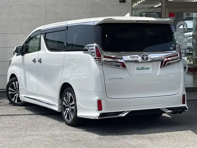 トヨタ アルファード S Cパッケージ 兵庫県 2019(令1)年 5.9万km ホワイトパールクリスタルシャイン アルパイン11インチナビ/（フルセグTV/DVD/Bluetooth）/アルパイン12.8インチフリップダウンモニター/モデリスタエアロ/モデリスタマフラー/衝突軽減ブレーキ/レーダークルーズコントロール/クリアランスソナー/電動パーキングブレーキ/前後ドライブレコーダー/MTモード付AT/ETC/合皮ブラックシート/運転席シートメモリ/１，２列目電動シート/前席シートヒーター/前席エアシート/ステアリングヒーター/オットマン/サンシェード/フロアマット/両側パワースライド/パワーバックドア/サンルーフ/ムーンルーフ/3連LEDヘッドライト/フォグランプ/シーケンシャルウィンカー/ウィンカーミラー/電格ミラー/ドアバイザー