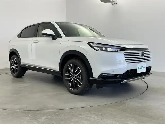 ホンダ ヴェゼル ハイブリッド e:HEV Z 愛知県 2025(令7)年 0.1千km プラチナホワイトパール 登録済み未使用車/ワイヤレス充電/純正9インチナビ/Apple CarPlay/Android Auto/Bluetooth/バックカメラ　/フルセグTV/ホンダセンシング/衝突被害軽減システム/クルーズコントロール/横滑り防止装置/コーナーセンサー/レーンキープアシスト/ブラインドスポットモニター/オートライト/オートマチックハイビーム/LEDヘッドライト/LEDフォグランプ/電動リアゲート/シートヒーター/ステアリングヒーター/パドルシフト/フルフラットシート/チップアップシート/ETC2.0/純正AW/スマートキー/スペアキー