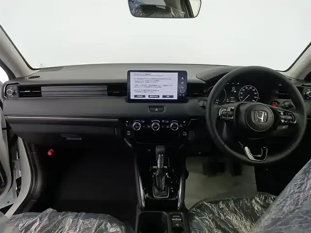 ホンダ ヴェゼル ハイブリッド e:HEV Z 愛知県 2025(令7)年 0.1千km プラチナホワイトパール ホンダセンシング/衝突被害軽減システム/クルーズコントロール/横滑り防止装置/コーナーセンサー/レーンキープアシスト/ブラインドスポットモニター/オートライト/オートマチックハイビーム/ワイヤレス充電器/純正9インチナビ/Apple CarPlay/Android Auto/Bluetooth/バックカメラ　/フルセグTV/LEDヘッドライト/LEDフォグランプ/電動リアゲート/シートヒーター/ステアリングヒーター/フルフラットシート/チップアップシート/ETC2.0/純正AW/スマートキー/スペアキー