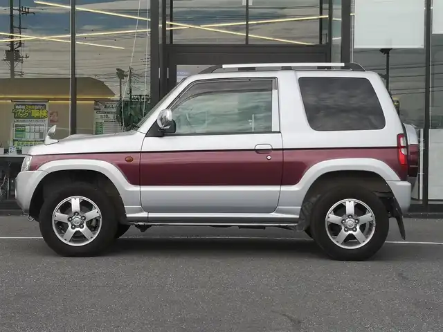 三菱 パジェロ ミニ エクシード 茨城県 2010(平22)年 5万km クールシルバーM/ラズベリーレッドP 純正チューナー/【ラジオ・CD・USB・AUX】/ルーフレール/ETC/４WD/ハロゲンライト/Fフォグ/ヘッドライトレベライザー/電格ミラー/純正フロアマット/純正アルミホイール/ドアバイザー/背面タイヤ