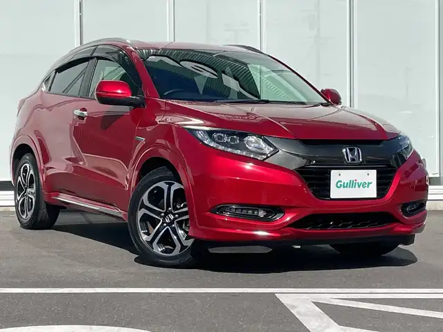ホンダ ヴェゼル ハイブリッド Z ホンダセンシング 神奈川県 2017(平29)年 5.4万km プレミアムクリスタルレッドM 純正メモリナビ（VXM-175VFi）/Bluetooth/CD/DVD/フルセグ/USB/追従式クルーズコントロール/前席シートヒーター/パドルシフト/パーキングセンサー/ルーフレール/LEDヘッドライト/LEDフォグランプ/ブレーキホールド/シートポジションメモリー/プッシュスタート/スマートキー/純正アルミホイール/純正フロアマット/ETC/電動格納ミラー/ドアバイザー/横滑り防止装置/レーンキープアシスト/衝突被害軽減システム