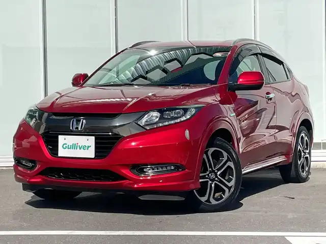 ホンダ ヴェゼル ハイブリッド Z ホンダセンシング 神奈川県 2017(平29)年 5.4万km プレミアムクリスタルレッドM 純正メモリナビ（VXM-175VFi）/Bluetooth/CD/DVD/フルセグ/USB/追従式クルーズコントロール/前席シートヒーター/パドルシフト/パーキングセンサー/ルーフレール/LEDヘッドライト/LEDフォグランプ/ブレーキホールド/シートポジションメモリー/プッシュスタート/スマートキー/純正アルミホイール/純正フロアマット/ETC/電動格納ミラー/ドアバイザー/横滑り防止装置/レーンキープアシスト/衝突被害軽減システム