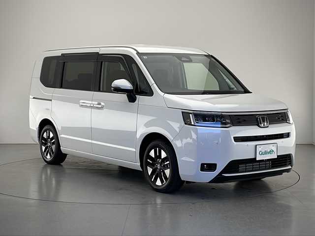 ホンダ ステップワゴン エアー EX 長野県 2025(令7)年 0.1千km プラチナホワイトパール 4WD/純正メモリナビ/（フルセグTV＆BL＆AppleCarPay＆AndroidAuto＆USB＆FM・AM）/全周囲カメラ/寒冷地仕様/クルーズコントロール（追従あり）/レーンキープアシスト/衝突被害軽減システム/クリアランスソナー/両側パワースライドドア/オットマン（2列目）/サンシェード（2列目）/パドルシフト/電動パーキングブレーキ/ブレーキホールド/LEDヘッドライト/オートマチックハイビーム/フォグランプ/ドアバイザー/ETC/シートヒーター（前席）/スマートキー/スペアキー