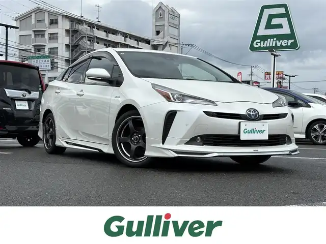 トヨタ プリウス A プレミアム 大分県 2019(平31)年 6.8万km ホワイトパールクリスタルシャイン ・純正9インチナビ/・フルセグテレビ/・バックカメラ/・モデリスタ/・AC100V/・レザーシート/・シートヒーターエアシートD+N/・ETC/・前後コーナーセンサー/・スペアキー/・オートマティックハイビーム/・ヘッドアップディスプレイ/・ワイヤレス充電/・ブラインドスポットモニター/・パワーシート