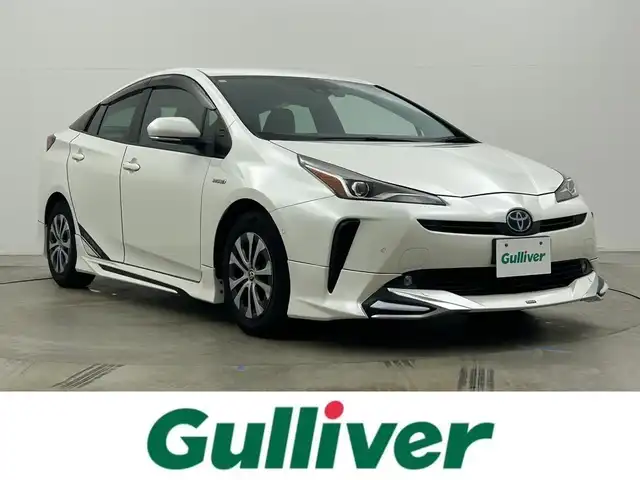 トヨタ プリウス A プレミアム 岡山県 2019(平31)年 7.2万km ホワイトパールクリスタルシャイン モデリスタエアロ/純正9インチナビ/・FM/AM/Bluetooth/フルセグ/CD/DVD/バックカメラ/合皮シート/・パワーシート/・ベンチレーション/アクセサリーコンセント/パーキングアシスト/ビルトインETC/ドライブレコーダー/トヨタセーフティーセンス/・プリクラッシュセーフティ/・レーンキープアシスト/・コーナーセンサー/・レーダークルーズコントロール/・オートマチックハイビーム/HUD/LEDヘッドライト/・フォグライト/純正フロアマット